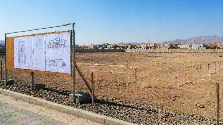 Empty UAE development plot at pre-mobilisation stage with ground markers and drawings pinned to a site board, representing the day one appointment point where independent PM delivers its highest value.
